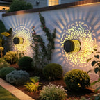 Solar lanterns lighting a garden wall at dusk