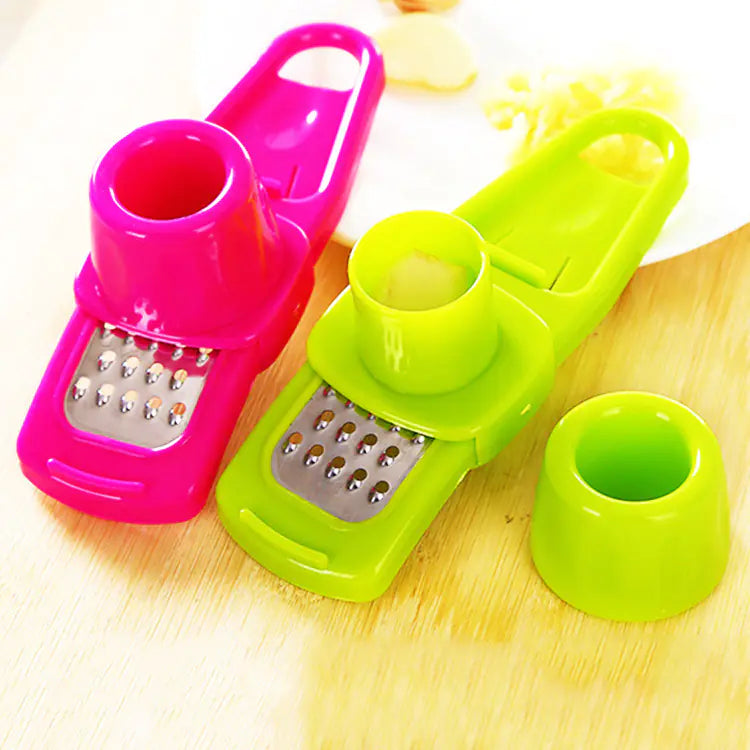 Roomlift garlic press on a cutting board with garlic